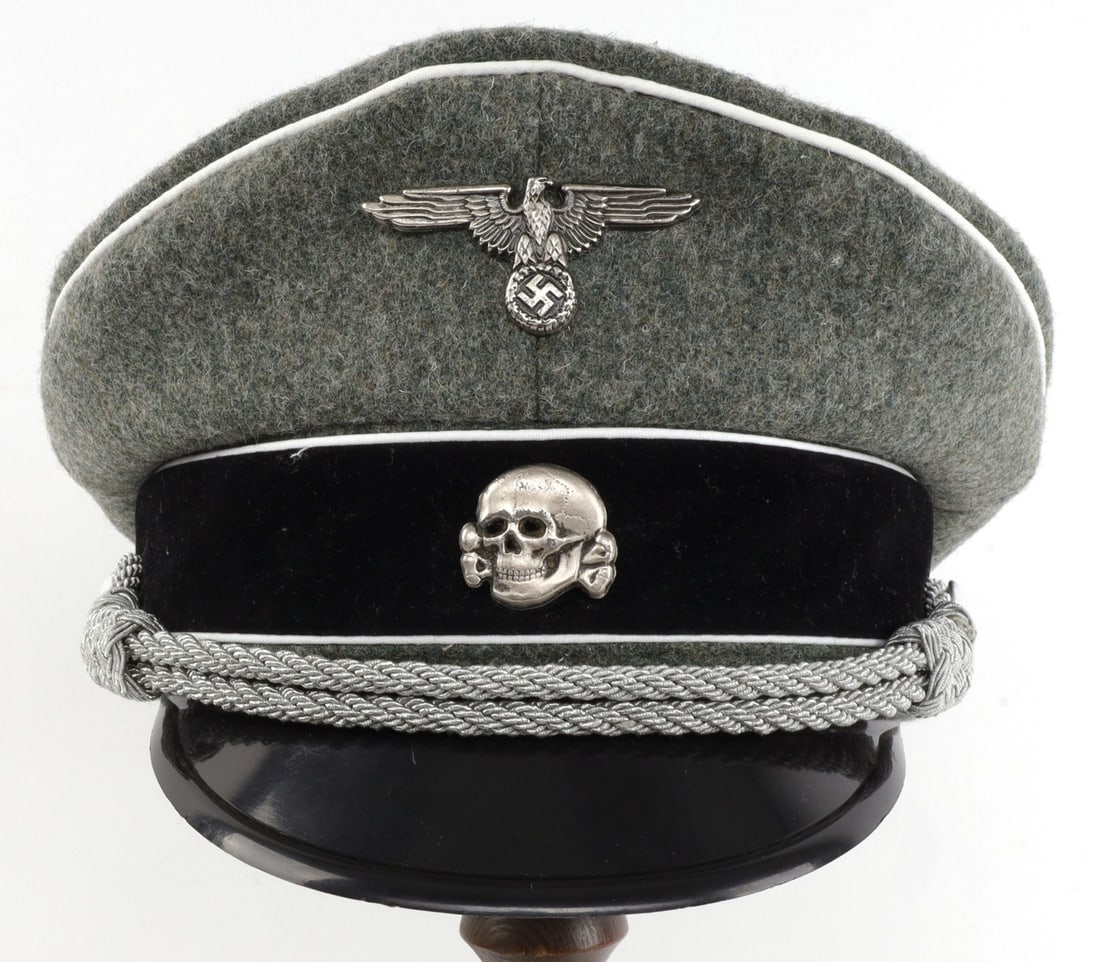 WWII GERMAN WAFFEN SS OFFICERS VISOR CAP: High-quality post-war piece. Size 6 3/4. Exterior of field gray wool with white piping. Complete with insignia, bullion cord, leather sweat band, celluloid sweat diamond and imitation silk liner. Near