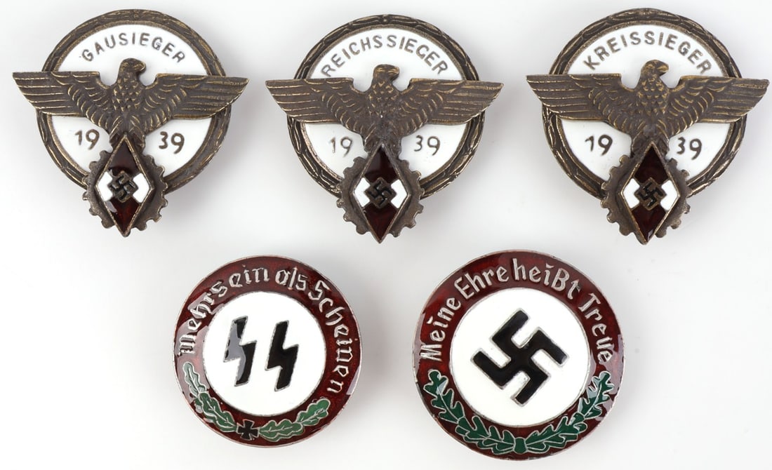 WWII GERMAN THIRD REICH BADGES LOT OF 5 HJ NSDAP: A collection of five enameled badges. 1939 Reichssieger, 1939 Kreissieger, 1939 Gausieger, Swastika badge, and SS Sieg-Runes badge. Unauthenticated, sold as is.