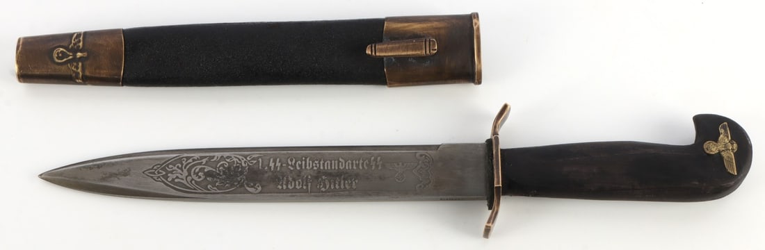 WWII GERMAN REICH LSSAH PRESENTATION BAYONET: Presentation bayonet for the Leibstandarte-SS "Adolf Hitler." Wood handle, leather and brass scabbard, and engraved blade. Bayonet is 12 inches total. Unauthenticated, sold "as is."