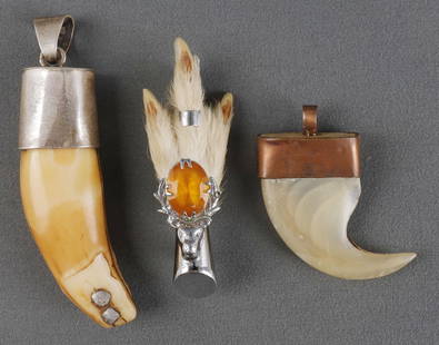 LION CLAW BEAR TOOTH PENDANTS & PHEASANT FOOT PIN: Bear tooth has sterling silver mounts. 3.75 inches measured along the curve (including loop.). Lion claw is 3 inches. The pheasant claw is 3 inches. This lot has a reserve.