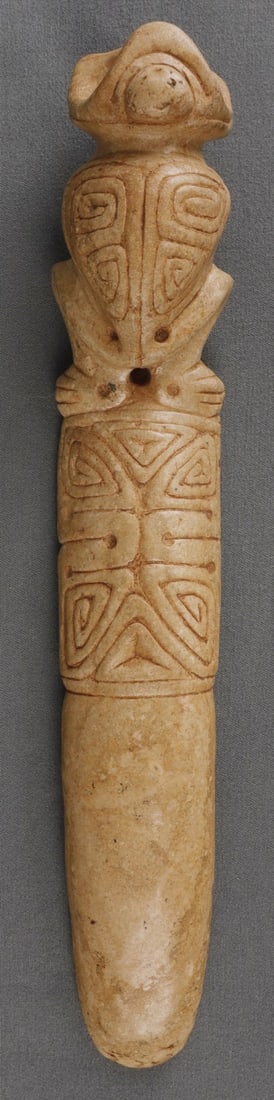 TAINO EXCEPTIONAL BIRD MAN VOMIT SPATULA: Taino exceptional bird man vomit spatula. Beautifully carved in full form. Large eyes suggest an owl. The beak is a bird head. Wings and chest are nicely incised. It measures 8.4 inches and crafted fr