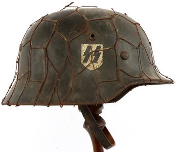 WWII GERMAN SS CHICKEN WIRE NS64 M40 STEEL HELMET: Waffen-SS M40 steel combat helmet with chicken wire cover. Right side exterior has single decal under vent hole. Interior stamped "NS64" at left ear and "0146" at neck apron. Retains liner and
