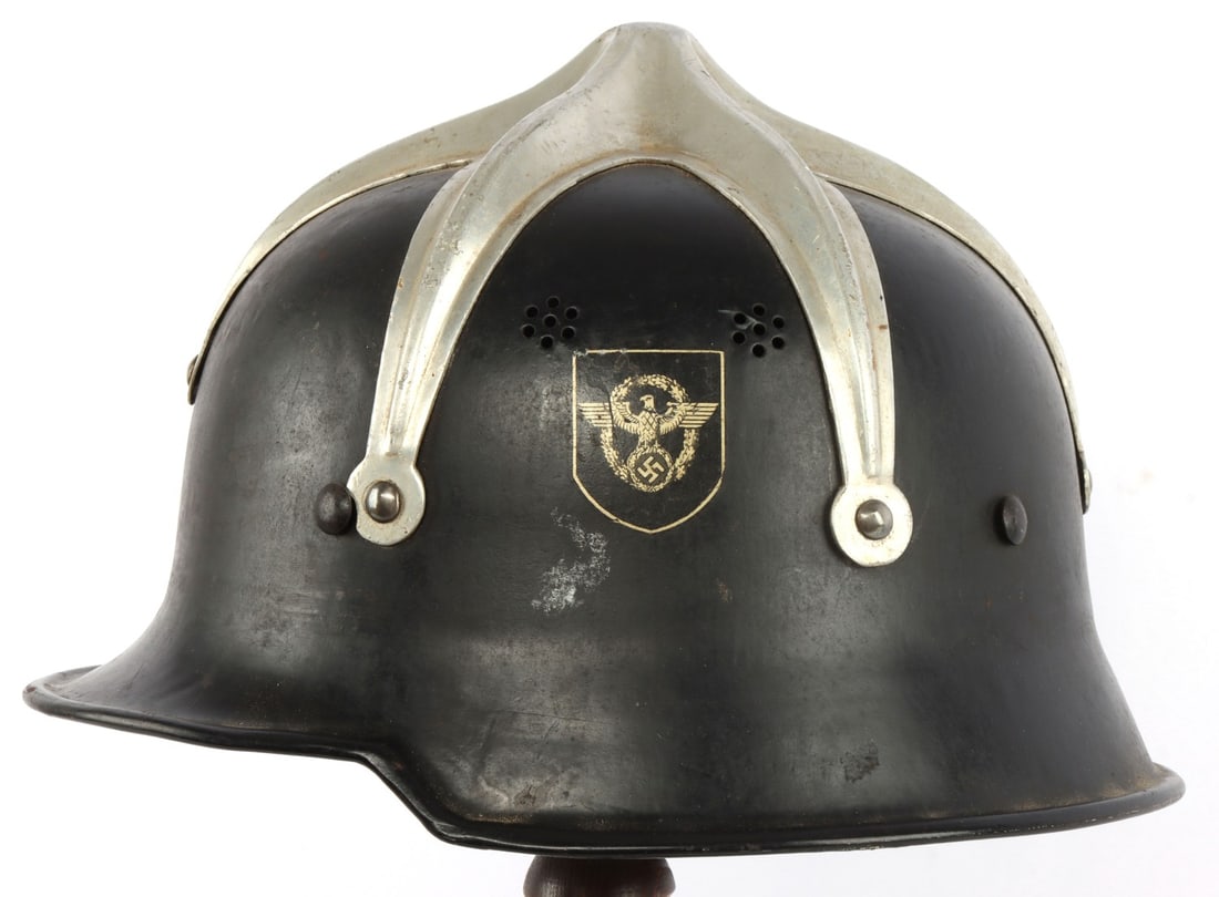 WWII GERMAN OCCUPIED HUNGARY FIRE POLICE HELMET: German double decal Ordnungspolizei steel helmet with Hungarian aluminum ridged crest riveted to the shell. Interior marked "D.R.P. Thale" at neck. Very good condition. Retains leather liner, padding 