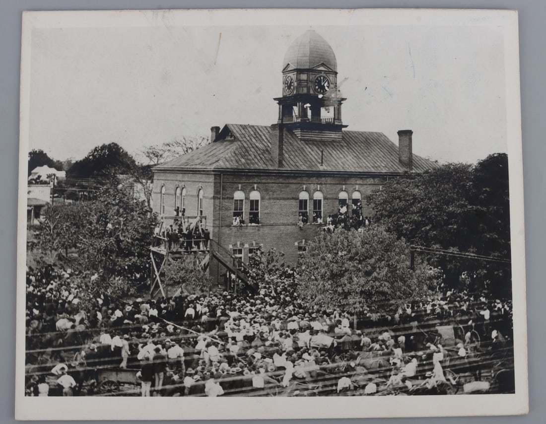 1908 CHARLESTON MISSISSIPPI HANGING PHOTOGRAPH: Board-backed photograph showing the hangings of Jim Bulleson and Ned Boles in Charleston, Mississippi. Both men had been convicted of murder. This lot also includes a document briefly detailing that c