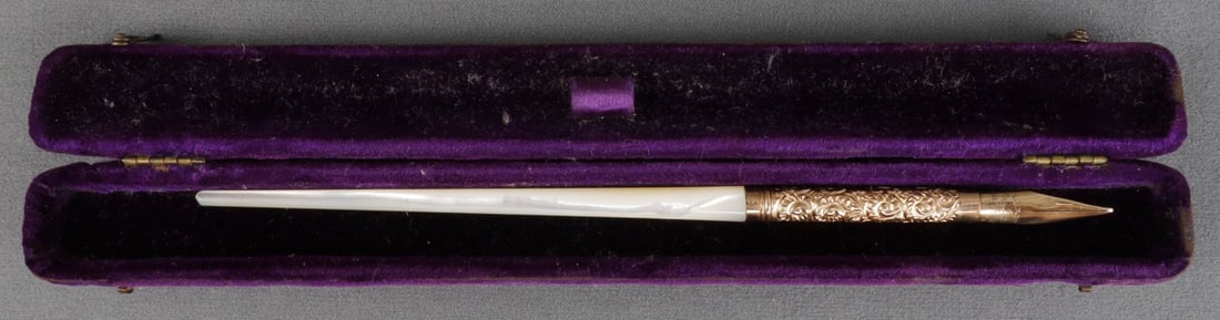 LEROY FAIRCHILD 14K GOLD NIB & GOLD FILL DIP PEN: The nib is 14K gold, and the the band under the nib is gold fill. The larger portion of the body is mother of pearl. In a purple carrying case. Very good, original condition.