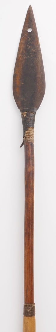 51 INCH IRON TIPPED TRIBAL CANE WOOD ARROW: Iron-tipped cane wood arrow with feather fletchings. Said to be South American, Amazon basin. Arrowhead is double-edged, quite sharp, with a single barb. Overall length: 51.25 inches. Arrowhead length