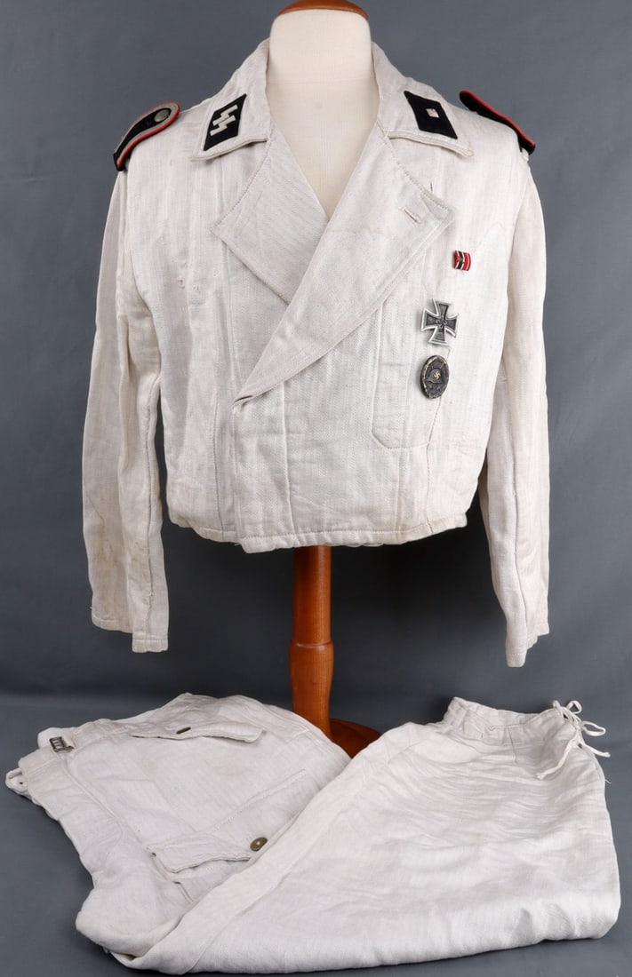 WWII GERMAN WAFFEN SS TROPICAL SERVICE UNIFORM: Tunic with drawstring pants. Inside pocket of tunic stamped, '50 54 96 56'. Includes shoulder boards, collar tabs, sleeve eagle, wound badge, iron cross, and ribbon bar. Inside waist of pants stamped,