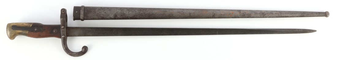 FRENCH MODEL 1874 SWORD BAYONET WITH SCABBARD: Imperial French M1874 sword bayonet for the Gras rifle. Manufactured 1879, St. Etienne. Includes scabbard (non-matching serial). Good condition. Slightly bent tip. Press stud is functional. Markings a
