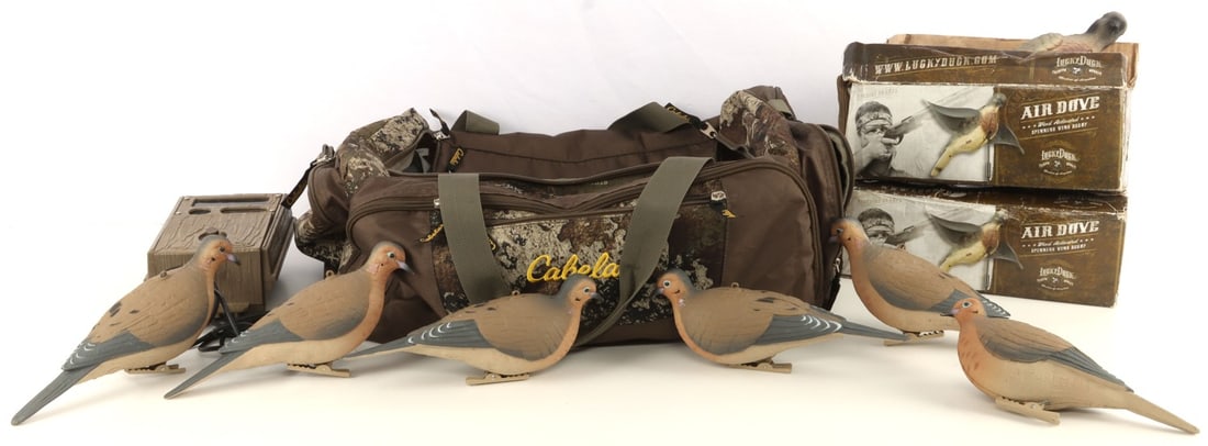 CABEL0'S HUNTING BAG W GAME CAMERA & DOVE DECOYS: Camera is untested. Some dove decoys are still boxed. Bag appears as new.