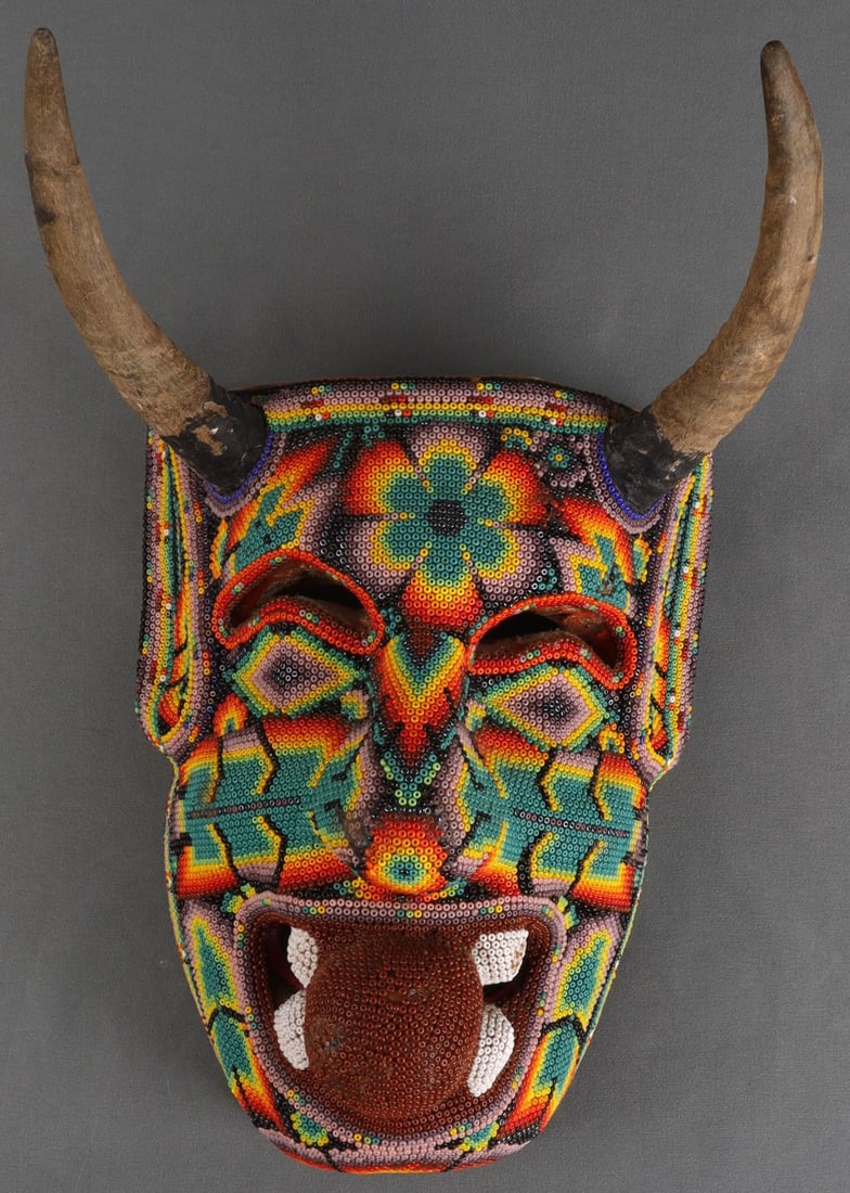 VINTAGE HUICHOL HORNED & BEADED DEMON MASK: Beaded mask of the Huichol people, likely representing a horned demon. Given the age of the peace, the substance used to attach the beads to the mask has congealed in some places, and other places hav