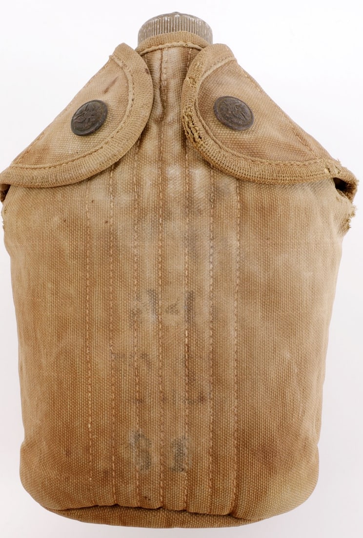 WWI US MODEL 1910 CANTEEN RIMMED EAGLE DESIGN: Model 1910 canteen with rare 'rimmed eagle' buttons. Canteen is marked 'TradeAMark' with the 'A' inside a diamond, stamped 'Made in U.S.A.' Cover appears to have been marked '44 US 21' at one point. V