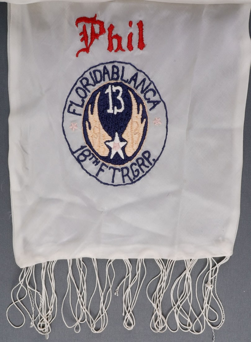 WWII US 13TH AIR FORCE 18TH FG EMBROIDERED SCARF: USAAF silk scarf embroidered with the insignia of the 13th Air Force and "Floridablanca, 18th Fighter Group." Personalized "Phil." Opposite end embroidered with a green dragon. Dimensions 52.5 X 9.5 i