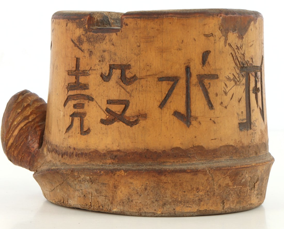 BATAAN DEATH MARCH CARVED BAMBOO CUP ASH TRAY: Bamboo vessel carved with kanji and notched twice on the top lip. Sheet metal fragment set in bottom of cup. Underside marked in pen "Bataan March [...]" partially legible, possibly "Juan/Joan Carling