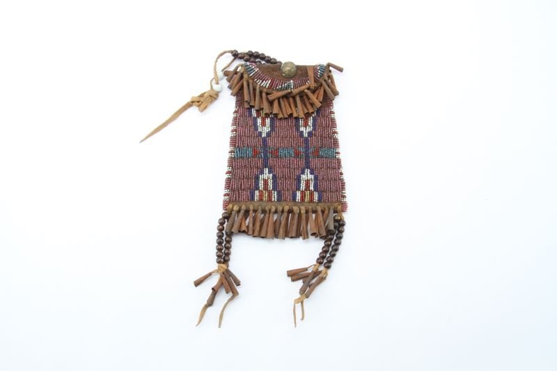 KIOWA PLAINS INDIAN STRIKE A LITE BEADED BAG: Dealers tagged stock, made from old saddle circa 1920's vintage but not antique, tight bead work with brain tanned leather.