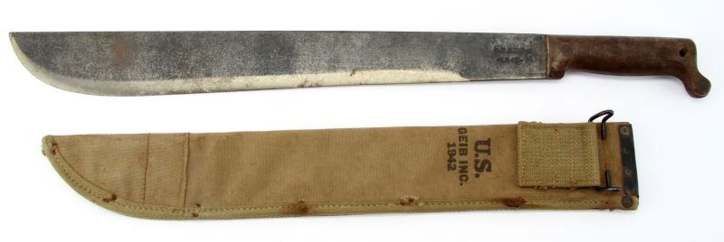 US TRU TEMPER 1945 MACHETE IN 1942 US SCABBARD: US Tru Temper machete dated 1945, in US GEIB, Inc 1942 dated canvas scabbard. Overall very good condition.