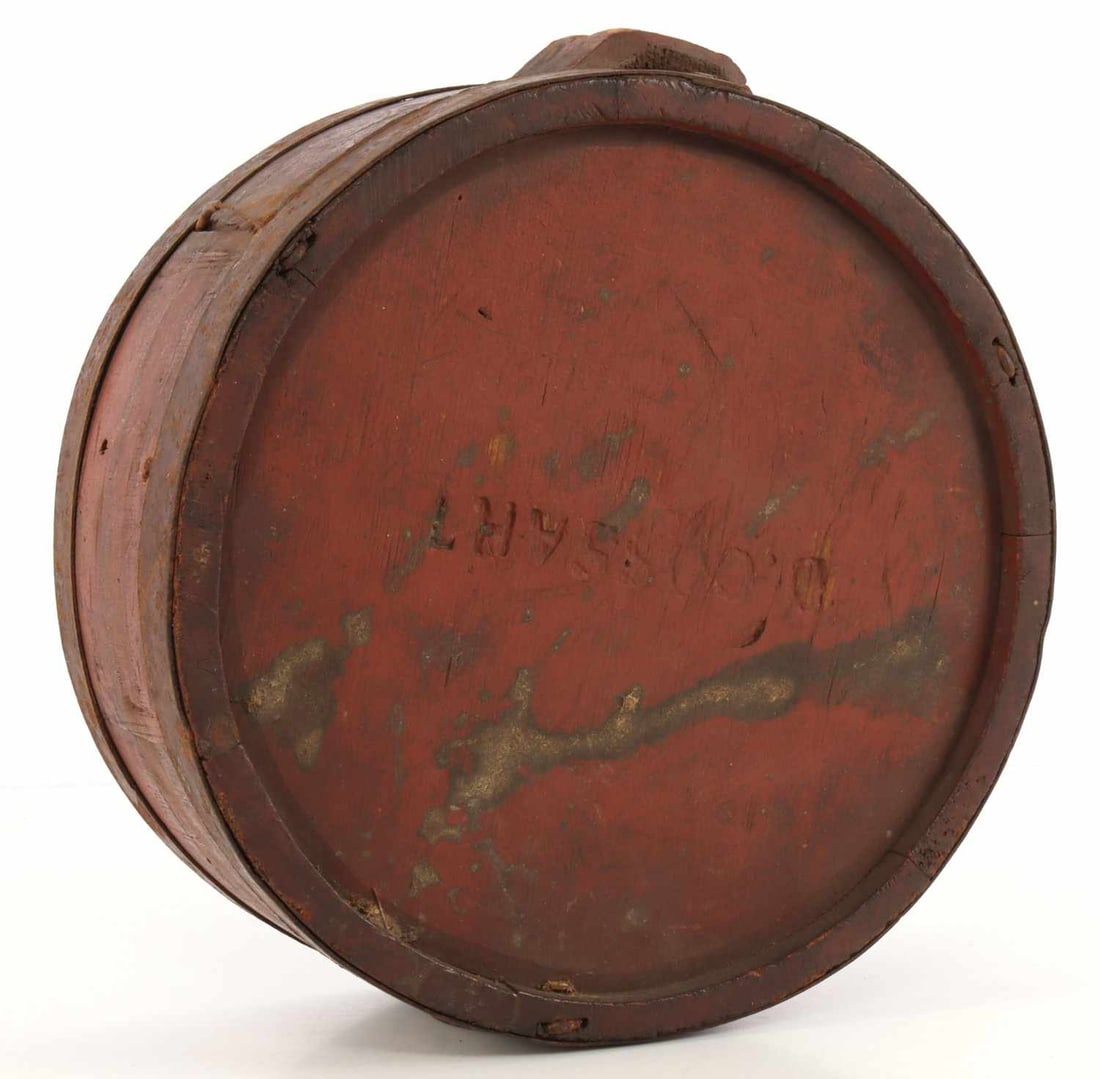 7 INCH US WAR OF 1812 DIAMETER CHEESEBOX CANTEEN: Cheesebox canteen from the War of 1812. Wood with red paint. Stamped 'D. Cossart,' a known maker, on one side plate. 7-inch diameter, 3.25-inch thickness. Very good, original condition.
