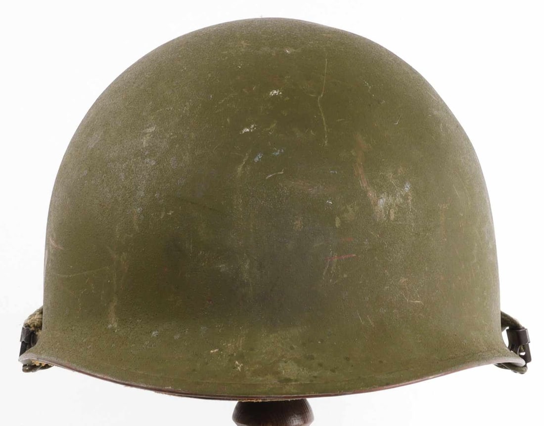 VIETNAM WAR US M1 HELMET WITH NAMED LINER: Rear seam, swivel chinstrap loops. Lot code "1 2203" stamped at visor. Liner dome interior has "US 4." With chinstrap. Good condition.