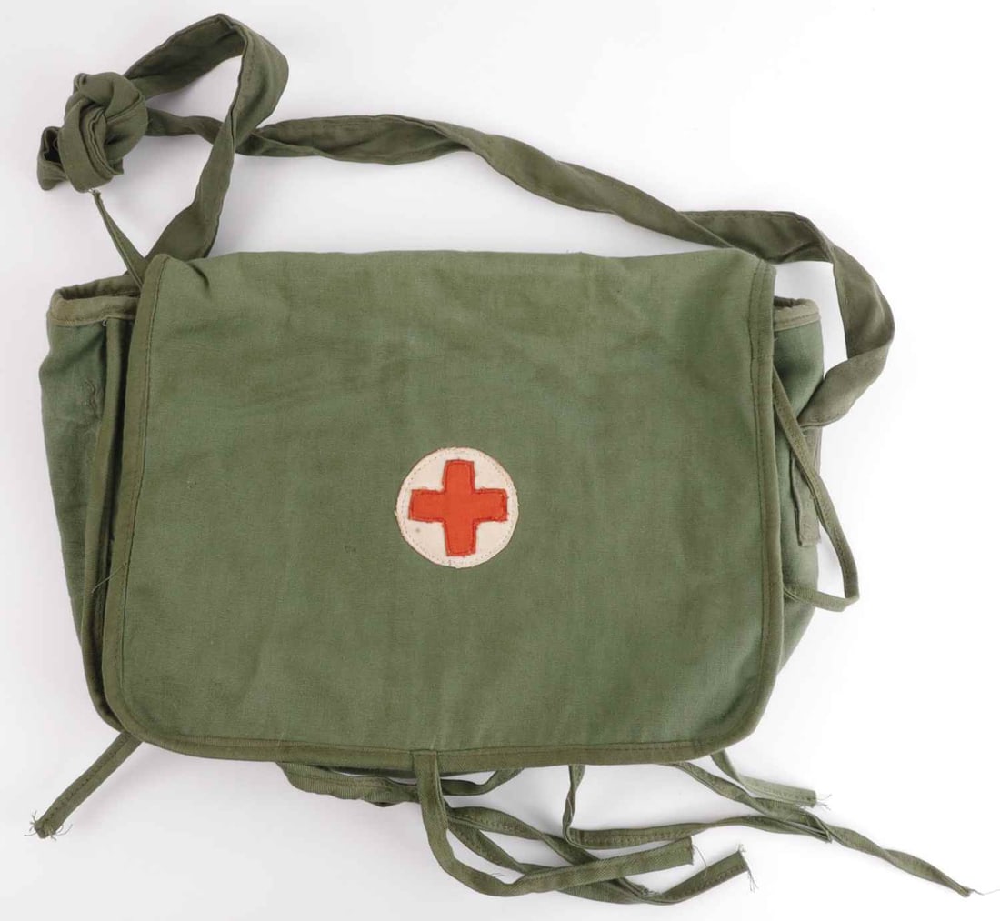 VIETNAM WAR VIET CONG MEDIC BAG IN GREEN: A Viet Cong or North Vietnamese Army medic bag in 'rainy season green,' sporting a red cross on a white field. 14 X 10 inches.