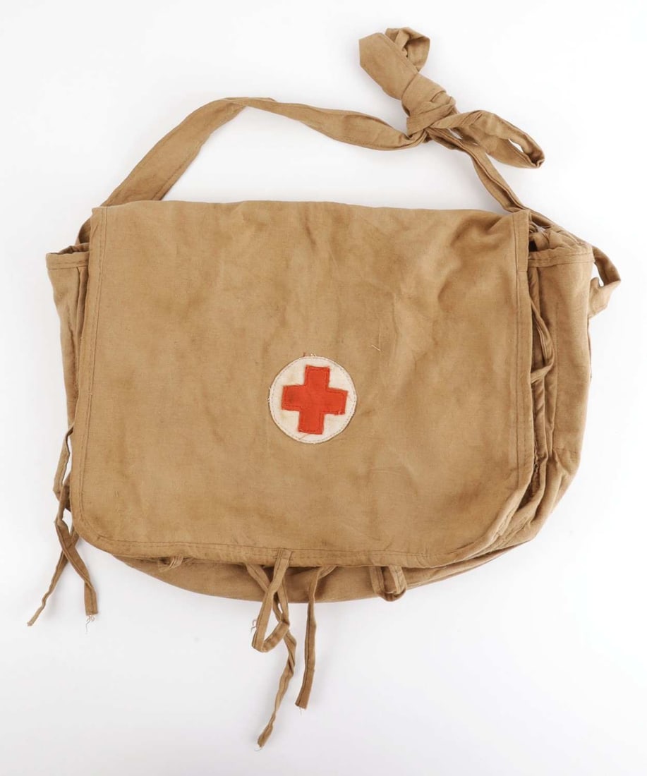 VIETNAM WAR VIET CONG MEDIC BAG IN KHAKI: A Viet Cong or North Vietnamese Army medic bag in khaki sporting a red cross on a white field. 14 X 10 inches.