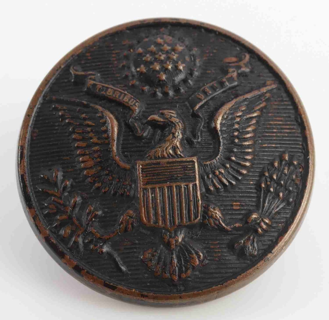WWI ACE EDDIE RICKENBACKER UNIFORM BUTTON WITH COA: US military uniform button owned by WWI fighter pilot Captain Eddie V. Rickenbacker. Includes notarized attestation of provenance signed by Rickenbacker's son, William F. Rickenbacker, and dated Janua