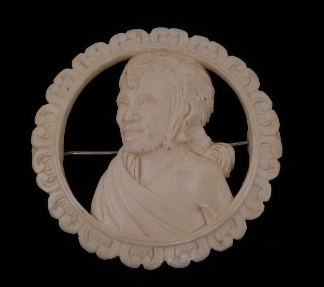 ANTIQUE IVORY NATIVE AMERICAN MAN BROOCH: As photographed. It measures 1 7/8 inches in diameter. No international shipping. Over 100 years old.