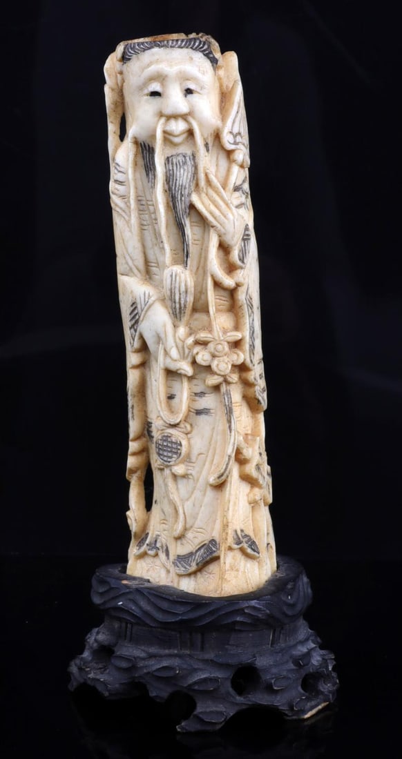 CARVED BONE STANDING CHINESE FIGURAL: A Chinese figural depicting a sage, carved from a cow bone and mounted on wood. Stands 6.5 inches, measured along the curve. In very good, original condition. This lot has a reserve.