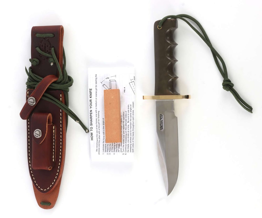 RANDALL MODEL 15 KNIFE WITH SHEATH: Features green Micarta grip, double hilt finger grip handle, top cutting edge. Blade measures 5 1/2 inches. New condition. This lot has a reserve.