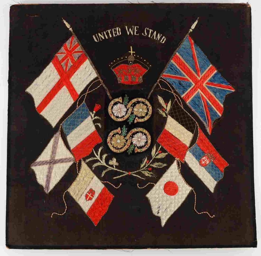 ANTIQUE UNITED WE STAND SAILOR MADE WOOLIE DISPLAY: Late 19th-early 20th century "woolie" silk display piece on thin cardboard. Features the British monarchy crown surrounded by weaved flag patterns of various allied nations, including the UK, France,