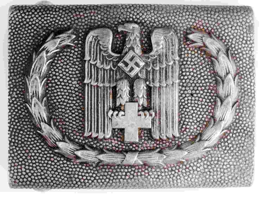 WWII GERMAN EARLY RED CROSS DRK EM BELT BUCKLE: Deutsches Rotes Kreuz injection molded aluminum belt buckle. Reverse marked "GES. GESCH. 1." Width 2.48 inches. Height 1.89 inches. Gross weight 18.4 grams. Very good condition.