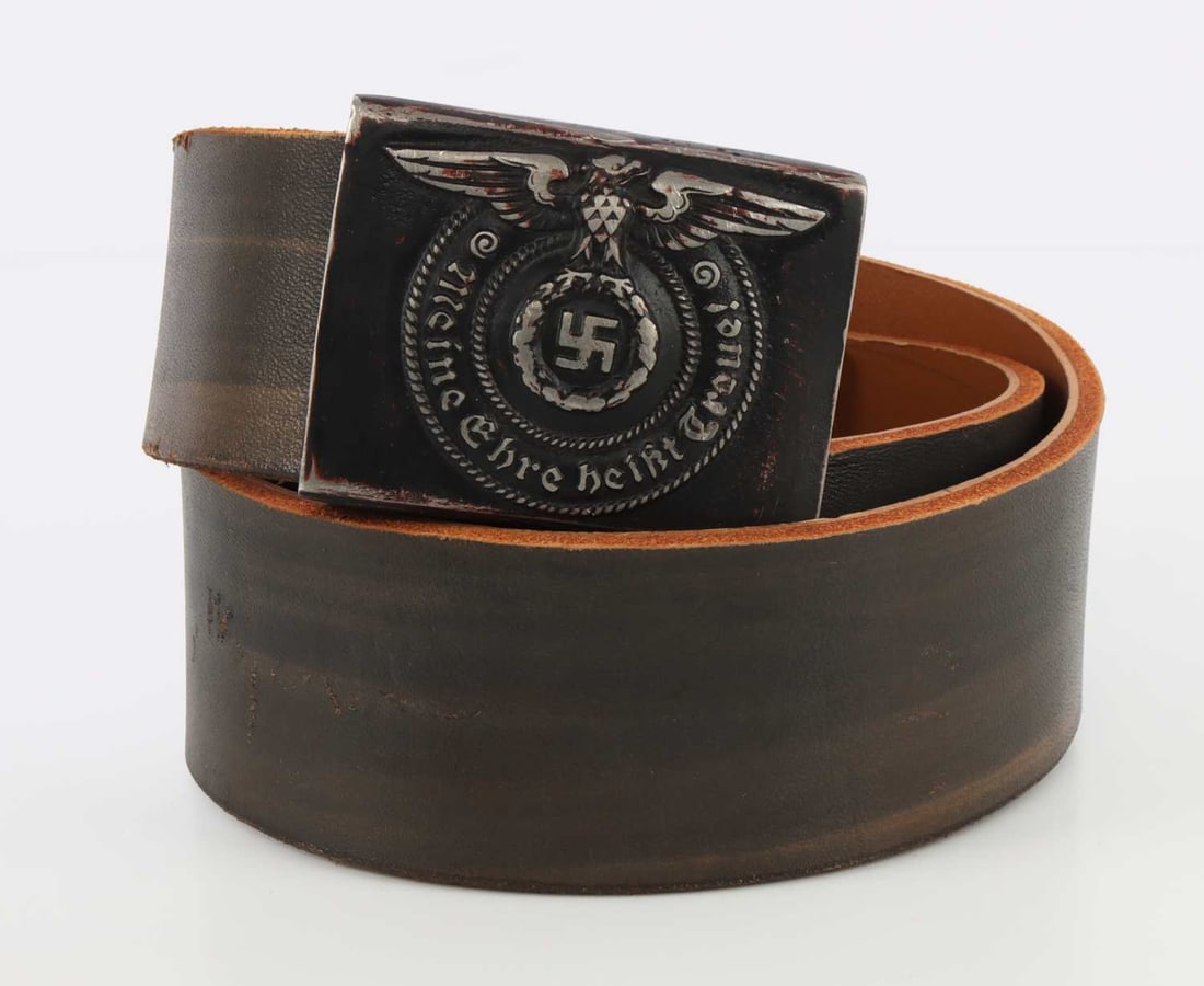 WWII GERMAN THIRD REICH WAFFEN-SS BELT & BUCKLE: A belt and buckle for the Waffen-SS. Bears a Reichsadler and reads 'Meine ehre heisst treue.' Buckle is 2.5 X 2 inches. Belt is 35 inches. Unauthenticated, sold as is.