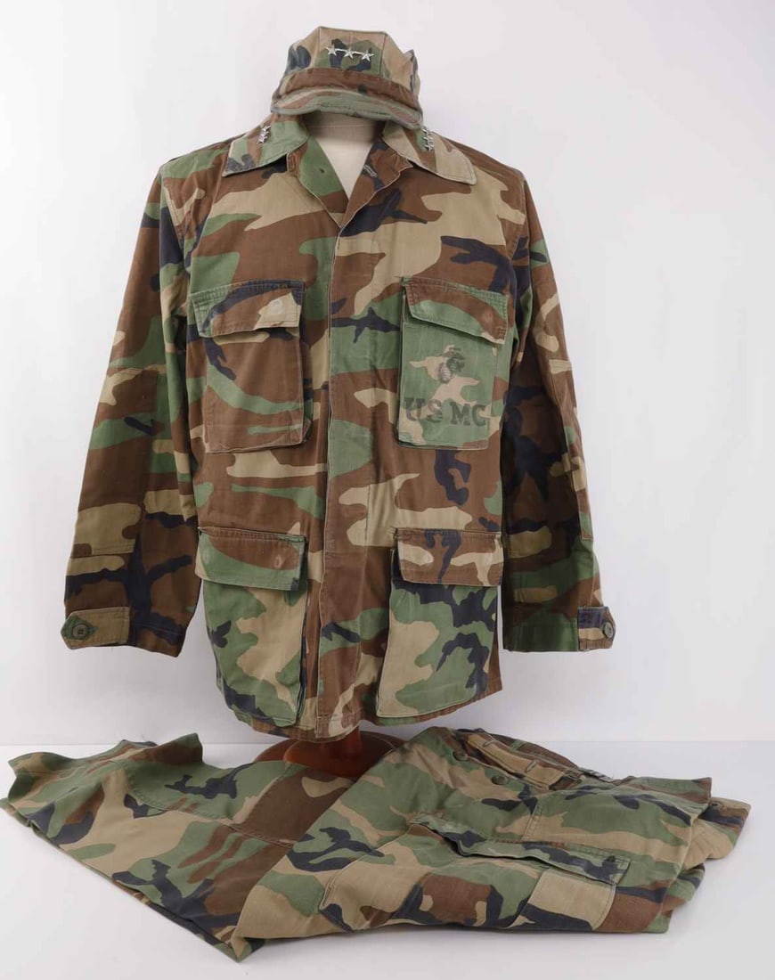US USMC GENERAL ROBERT MILLIGAN UNIFORM: Lot of THREE (3) items. Field camo uniform for Lt. Gen. Robert Milligan. 1) For tunic, chest is stamped USMC with plastic three stars pinned to collar. Tag worn beyond reading. 2) Camo pants. Tag is w