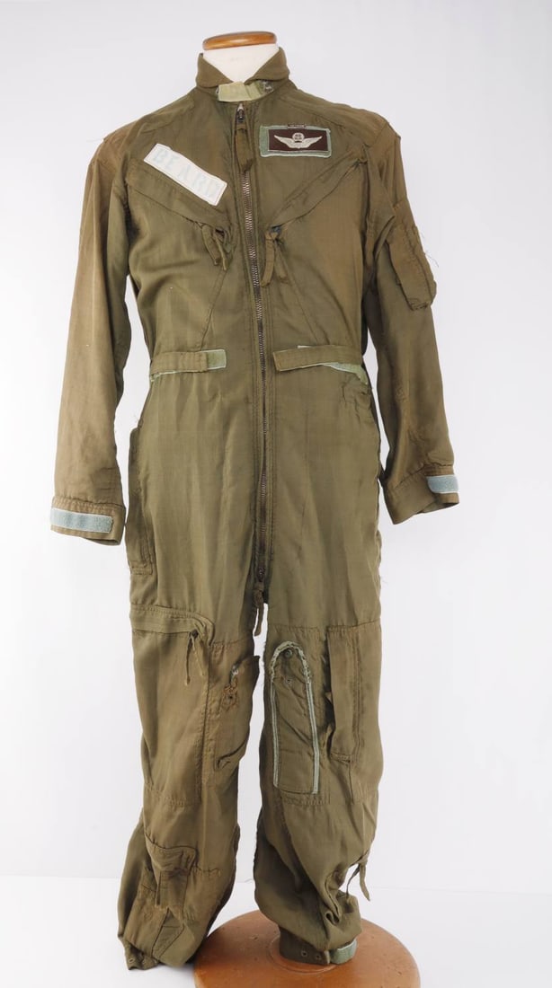 VIETNAM WAR US AIR FORCE NAMED FLIGHT SUIT: A slight suit from the United States Air Force during the Vietnam War. A series of tags on the front indicate that this is from the Vietnam War, and a name tag reads 'Beard.' Approximately a size medi