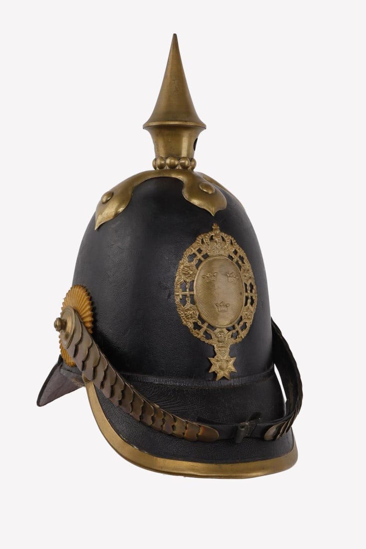 1840 SWEDISH OFFICERS SPIKED HELMET: Black lacquered leather. Brass spike, front plate, and chin strap. Interior diameter measures 7 1/2 inches. Overall it measures 12 X 12 inches. Some cracking in the leather but overall very good condi