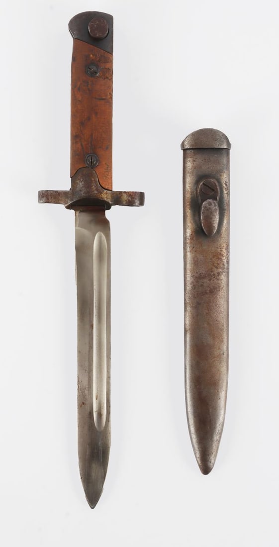 WWI ITALIAN M38 CARCANO BAYONET AND SHEATH: Original bayonet. Wood grip plates, steel blade, scabbard, crossguard. Serial number I70551. Measures 12 1/4 inches. Very good condition. From the collection of John Widdows, WW2 Collectibles. This lo