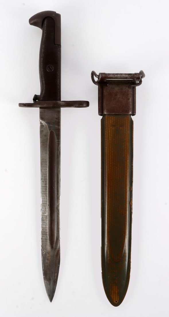 WWII US M1 GARAND BAYONET AFH: A bayonet for the M1 Garand. The blade is stamped 'AFH' for 'American Farm and Hoe' on one side, over a 'U.S' and flaming cannonball with no date stamp. Scabbard is original to the bayonet. 10 inch bl
