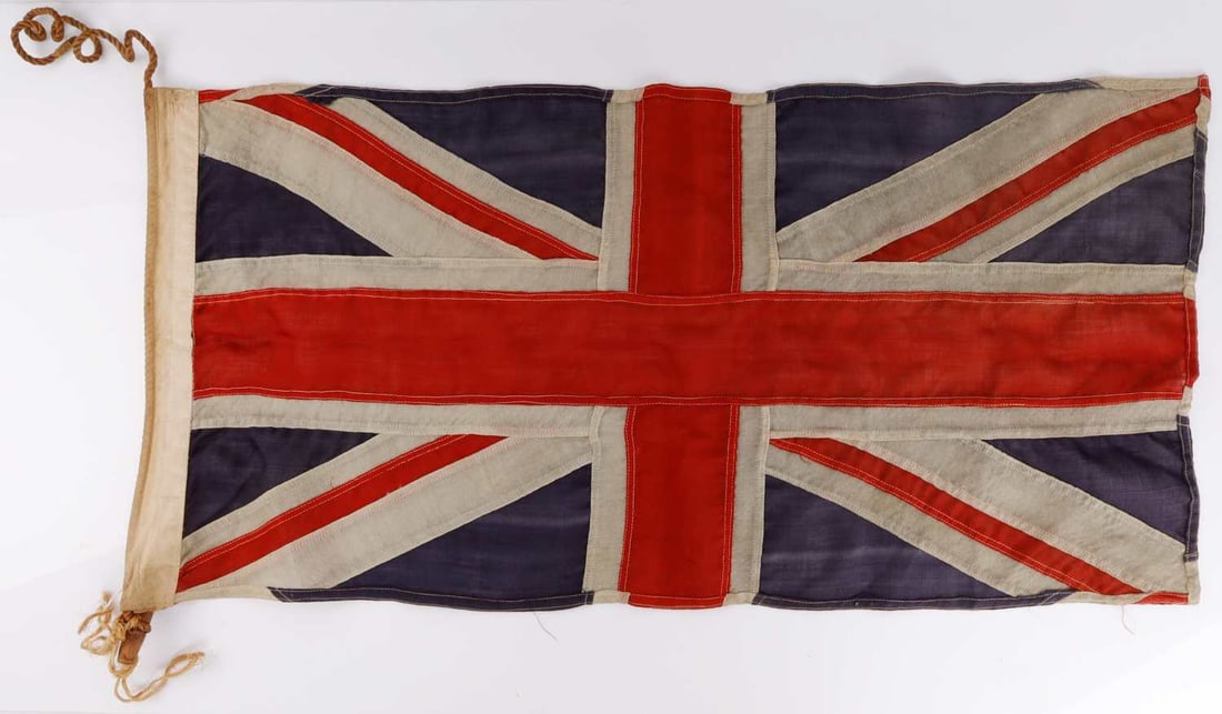 WWI BRITISH UNION JACK BATTLE FLAG: A Union Jack from the First World War. Marked as having been made by Scyco, a Canadian company. Multi-piece construction. 37.5 X 19 inche.s Very good, original condition.