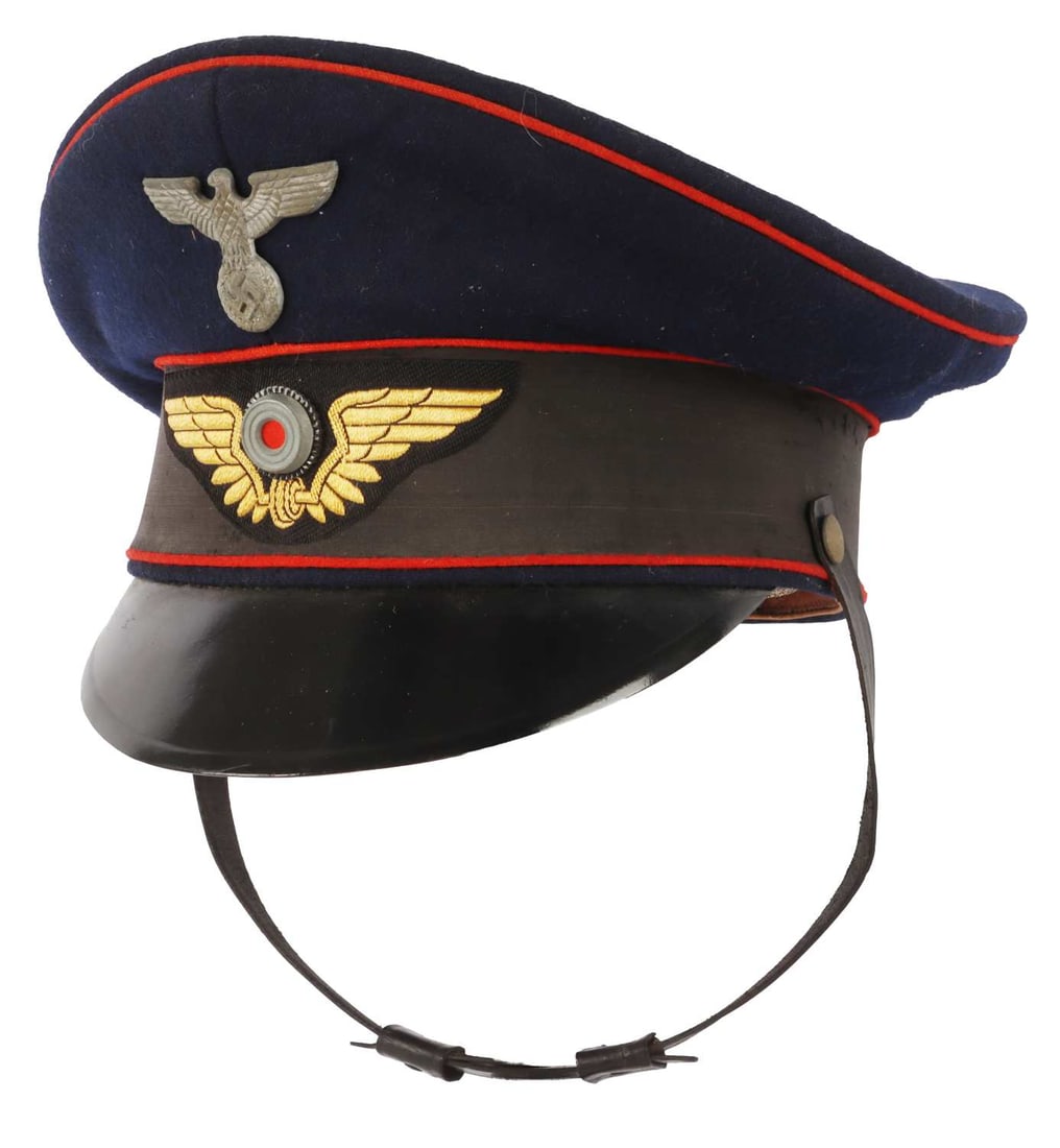 WWII GERMAN REICH RAILWAY OFFICER VISOR: Blue wool visor with zinc eagle and cockade. Railway insignia in patch form with gold bullion. Clemens Wagner make. Cork liner is in piece but overall condition of visor is very good. Non-fluorescing.