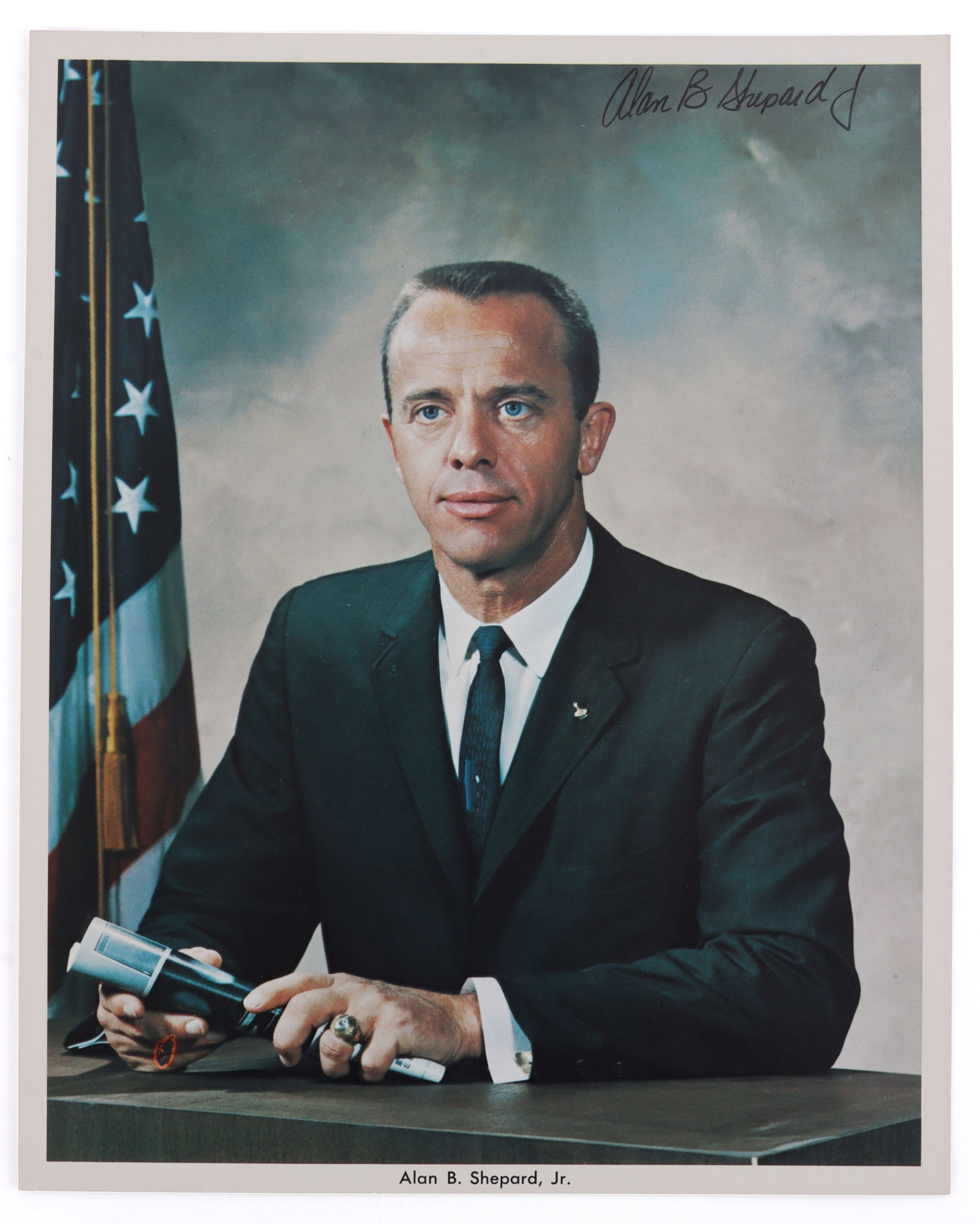 ALAN SHEPARD SIGNED HEAD SHOT PHOTO: An official head shot of Alan Shepard from NASA. Document is signed. This head shot and signature was collected by a former NASA employee. Very good, original condition.