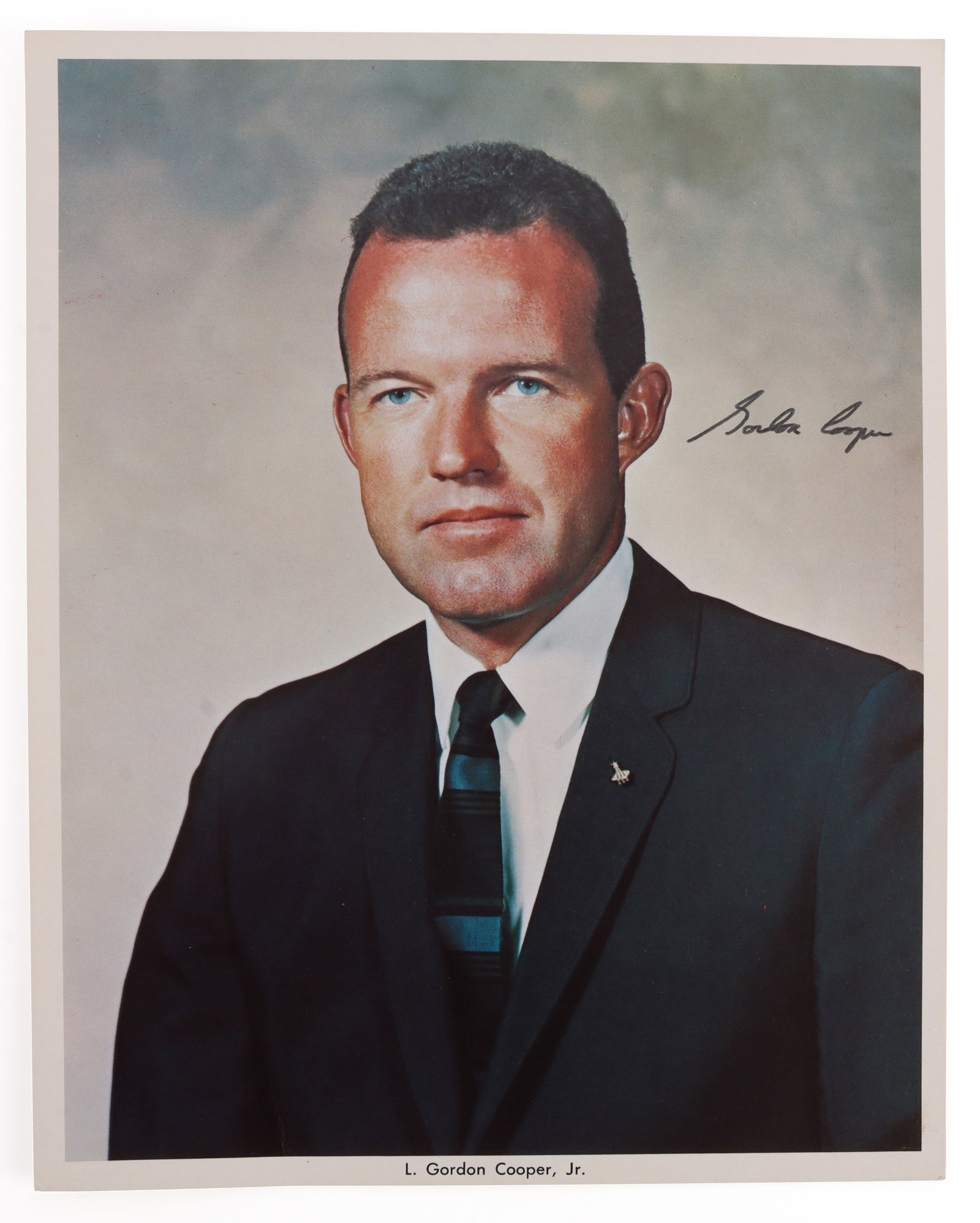 GORDON COOPER SIGNED HEAD SHOT PHOTO: An official head shot of Gordon Cooper from NASA. Cooper piloted the Faith 7, the last solo American space mission. Document is signed. This head shot and signature was collected by a former NASA empl