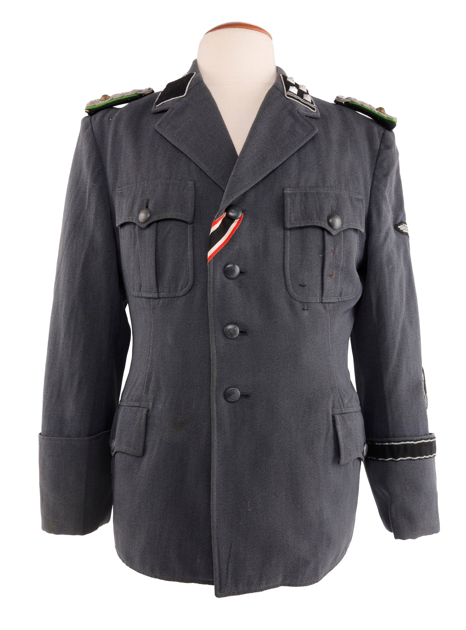 WWII GERMAN SD TUNIC OBERSTURMBANNFUHRER: Sicherheitsdienst tunic complete with collar tabs, SD patch, shoulder boards, cuff title, eagle patch, and ribbon. Dutch tailor. Buttons are zinc. Sleeve lining features wear. Partial silver bullion o