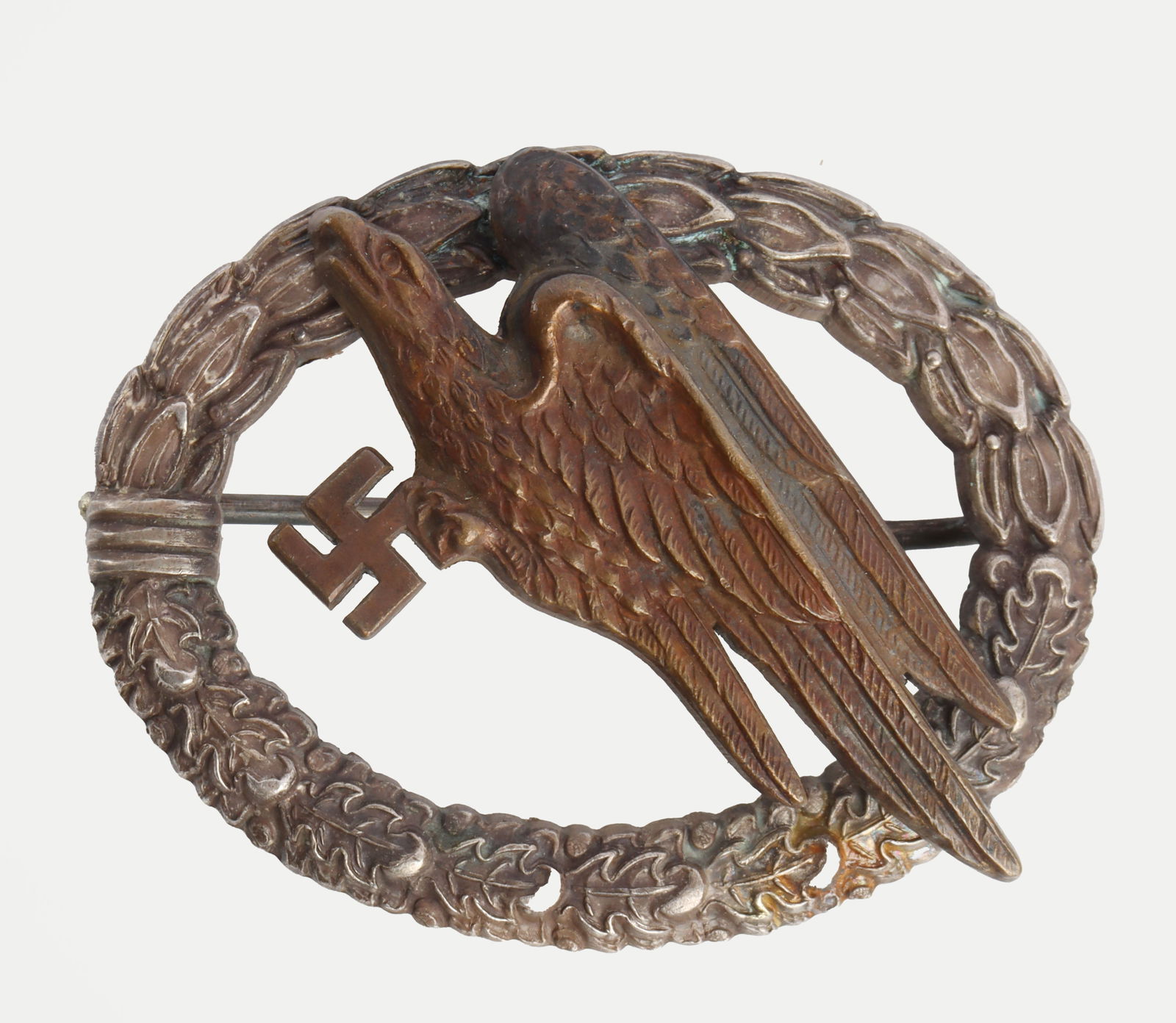 WWII GERMAN THIRD REICH PARATROOPER BADGE: A parachutist badge of the German Third Reich. A Luftwaffe eagle carrying a swastika, over a wreath of oak leaves. C. E. Juncker marked. C clasp. Gilt has largely worn off. A little over 2 inches in d
