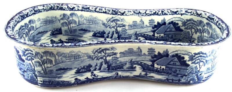 STAFFORDSHIRE BLUE & WHITE IRONSTONE BIDET: An English Ironstone bidet dating from about 1840. Blue stamp on bottom, Wild rose pattern with country scene on inside and around outside. 20.5 inches by 10.5 inches by 5 inches. No drain hole. In ve