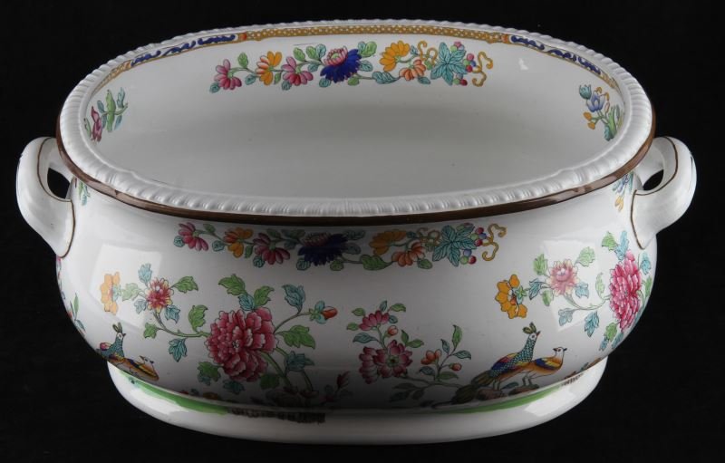 LARGE LATE-19TH CENTURY MORTLOCK SPODE FOOT BATH: Large English ceramic foot bath with hand-painted flowers and peacocks on the outside. Brown band around the outside rim and handles with flowers and blue and yellow pattern on inside rim. Mouth measu