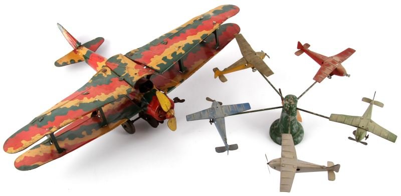 BRITISH TIN BIPLANE &1930'S TOY PLANE CAROUSEL: Tin 1940's wind up swing back wings camo biplane stamped Made In England, possible Corgi, working wheels and prop turns, also wood pedestal mono wing circa 1930's toy plane carousel. French-made, Over