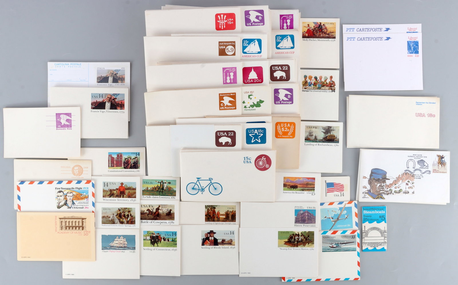LARGE LOT OF UNUSED POSTAGE ENVELOPES & POSTCARDS: All unused different periods and amounts.