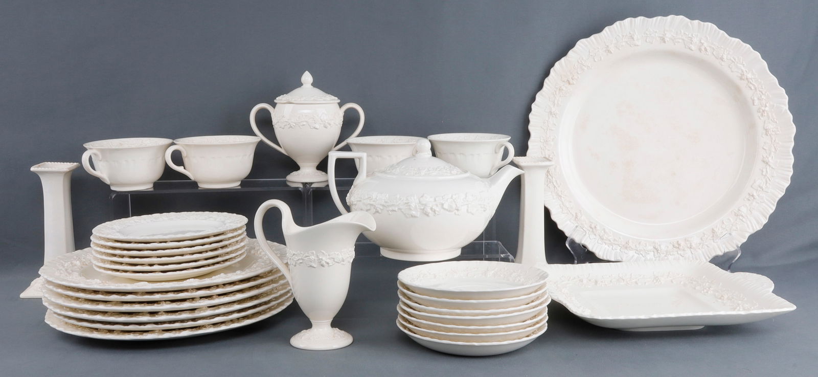 29 PC. WEDGWOOD EMBOSSED QUEENS WARE PATTERN 2243: Includes 1 creamer and sugar, 7 coffee plates, 4 coffee cups, 2 candle sticks, 7 10 inch dinner plates, 1 teapot, 5 saucers, 1 platter. Damage free sold as is.