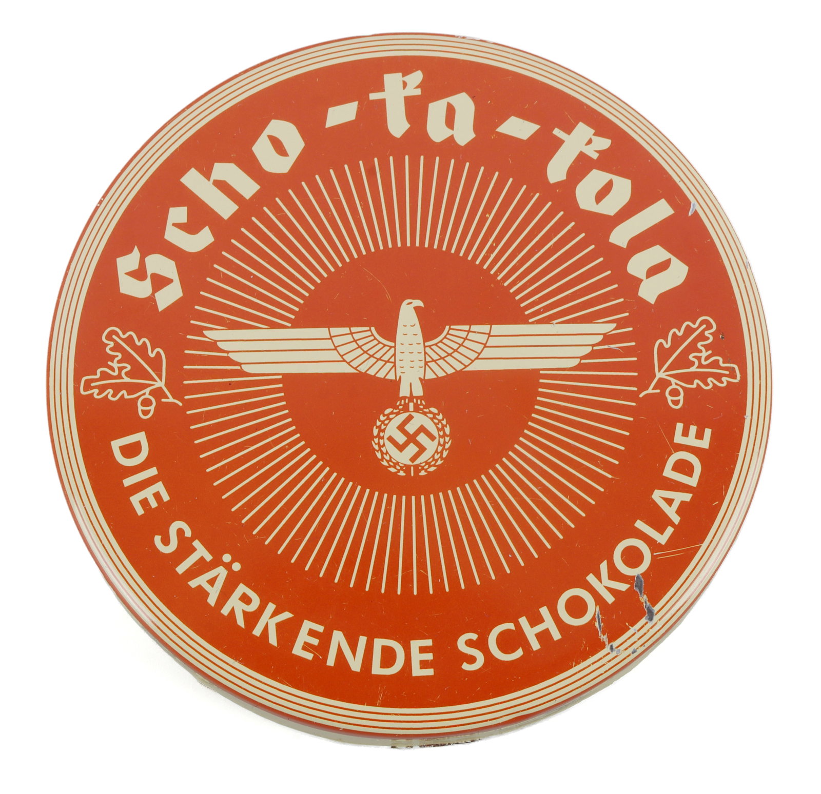 WWII GERMAN SCHO-KA-KOLA TIN WITH REICHSADLER: A tin for Scho-Ka-Kola, a popular 'sport chocolate' during the Third Reich made by blending chocolate, coffee, and cola nuts. Reichsadler on top of tin. 3.5 inch diameter. Remnants of the product rema