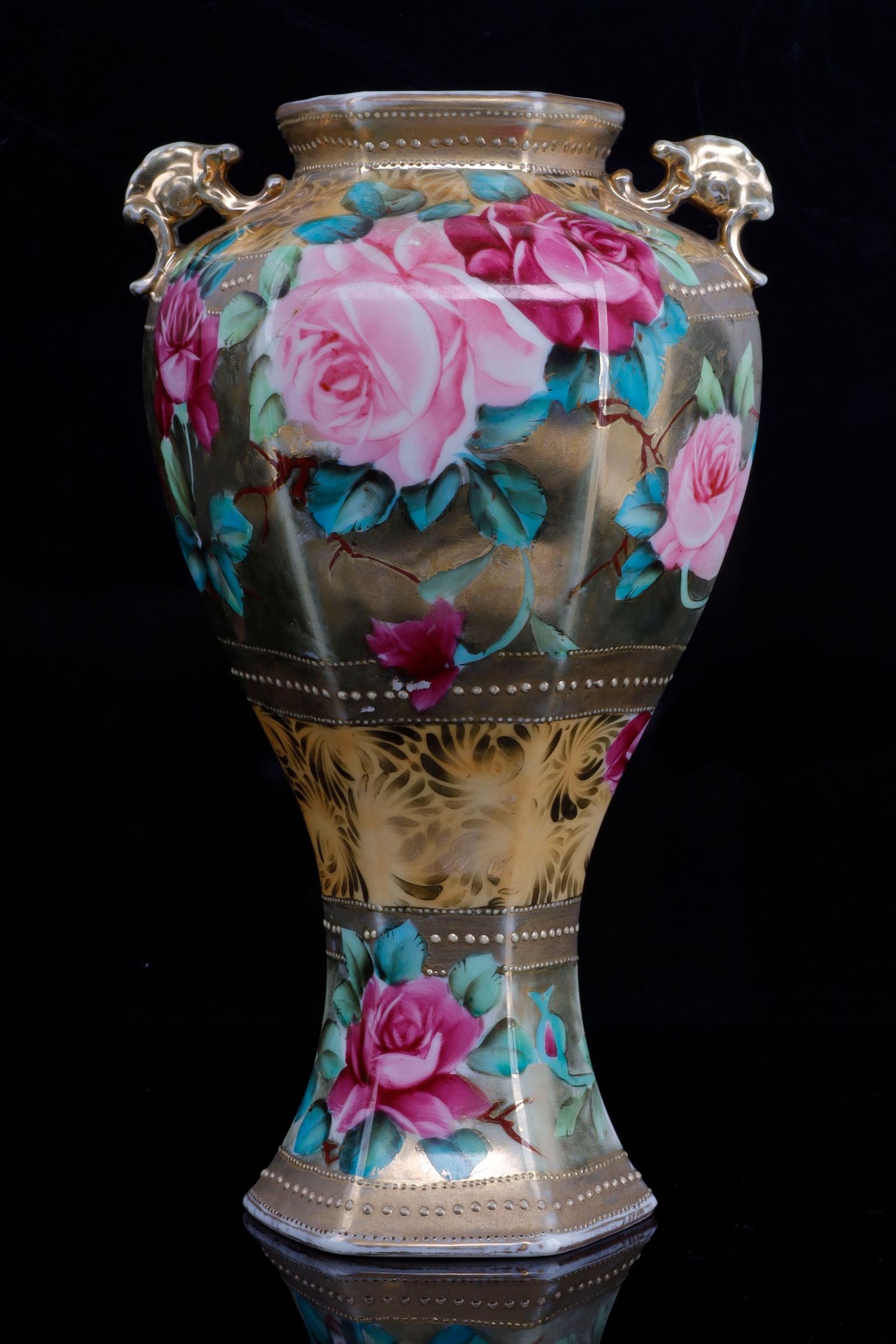 HAND PAINTED NIPPON VASE GOLD: Hand Painted Nippon vase. The vase is gold with pink roses and dotting. In some spots the paint has started to fade on the top and bottom. It is in over all very good condition. Sold as is