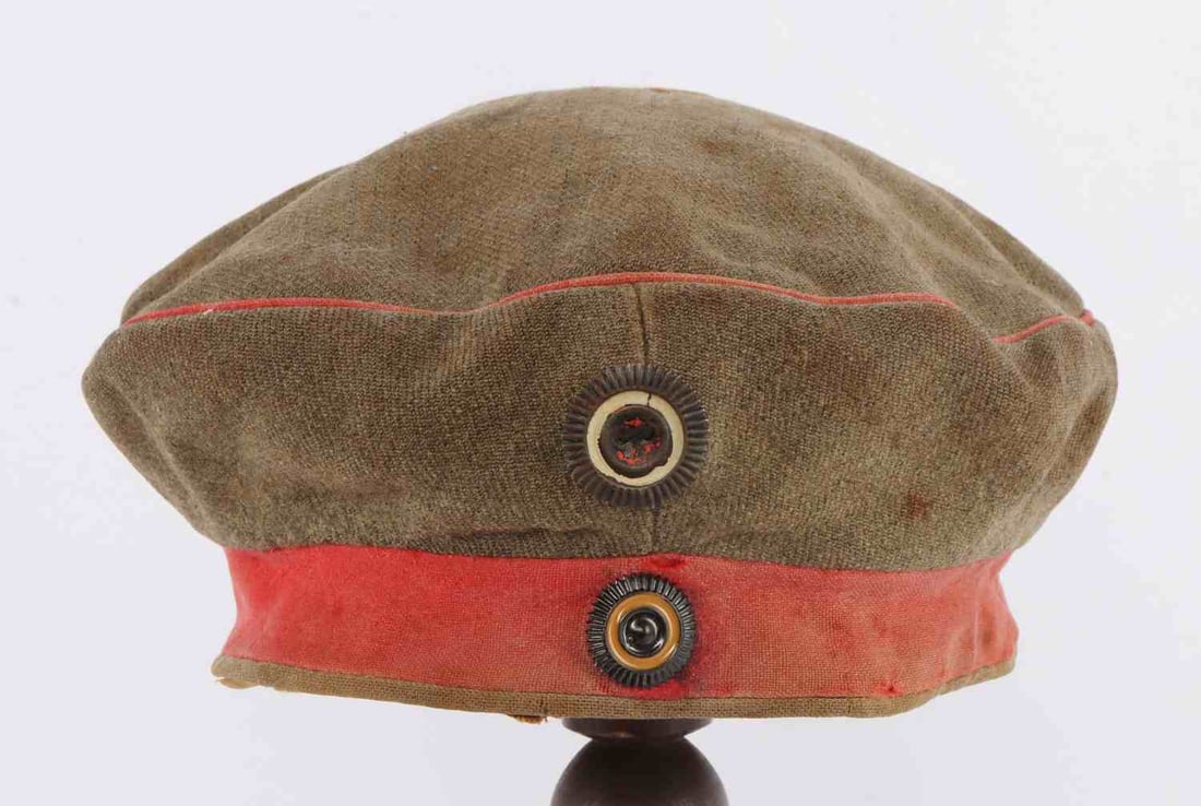 WWI IMPERIAL GERMAN FELDMUTZE FIELD CAP: Imperial German infantry feldmutze cap. Feldgrau with red piping and red band. Has lost some of its ability to stand free or upright due to age and wear, but would look as original on a mannequin or m