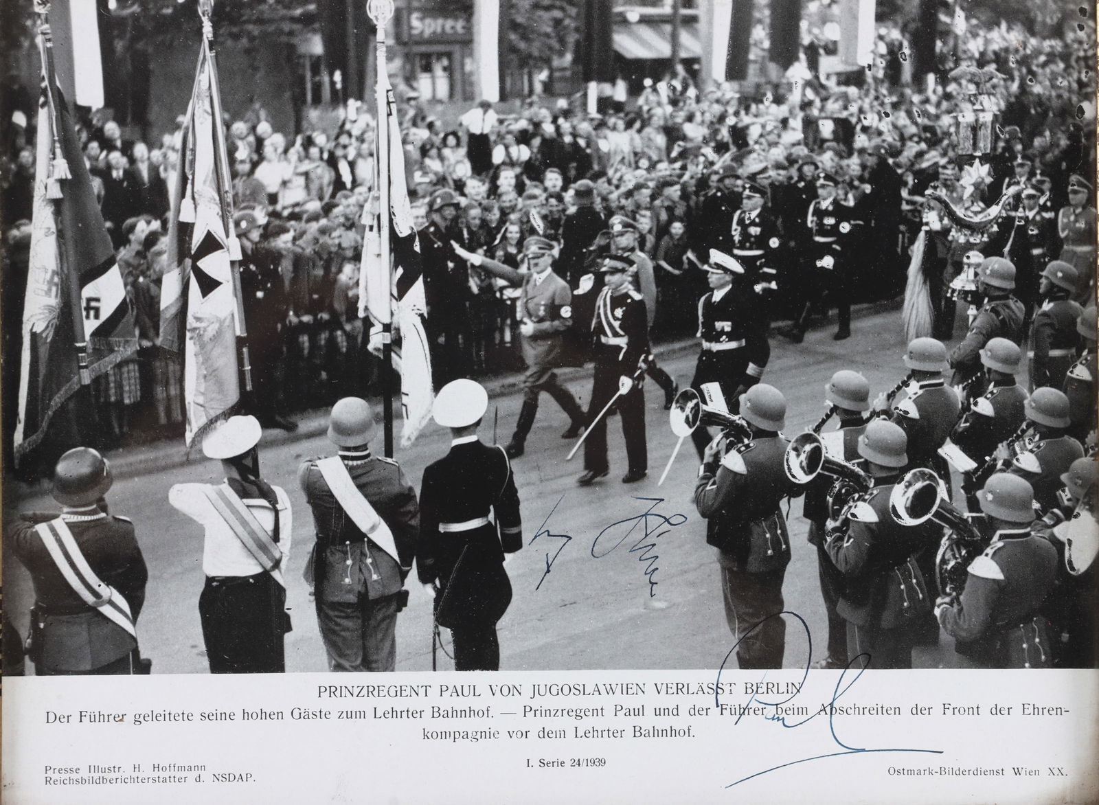 WWII ADOLF HITLER & PRINCE PAUL AUTOGRAPHED PHOTO: A photograph of an official visit between Adolf Hitler and Prince Paul of Yugoslavia, depicting a military parade. The photograph has been signed by Hitler and prince Paul. Certificate of authenticity
